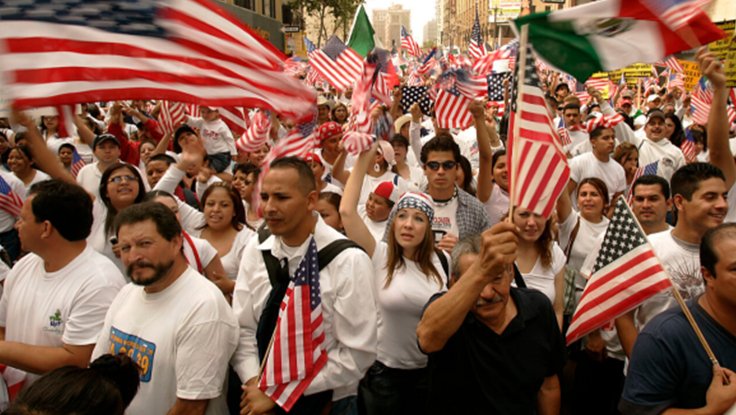 Crowd of people with American and Mexican flags boycotting United States schools and businesses in May 2016