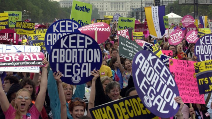 Crowd of women protestors with keep abortion legal and pro-choice signs marching at National Mall in Washington D.C. against Partial-Birth Abortion Ban Act in 2004